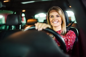 woman smiling driving car