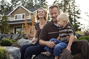 family sitting outside home